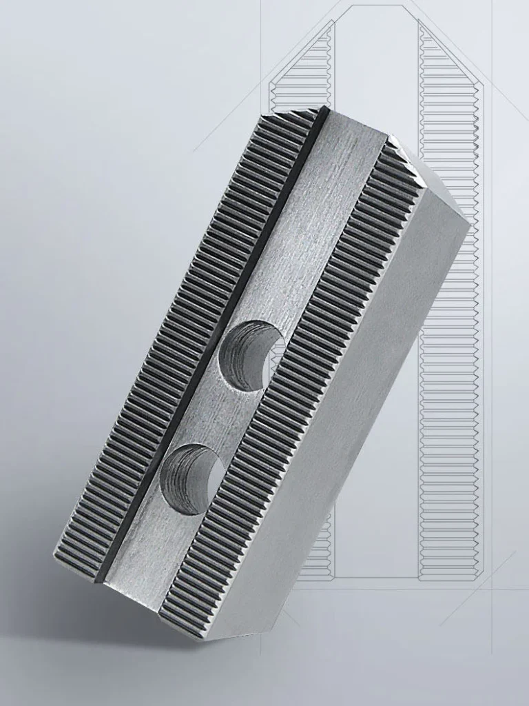 Rear view of one individual jaw for 3-jaw chuck featuring serrated friction teeth and two mounting holes