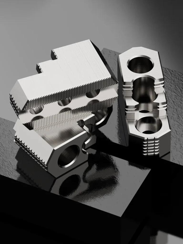 A set of three three-step hard jaws positioned in different orientations to show various angles and details.