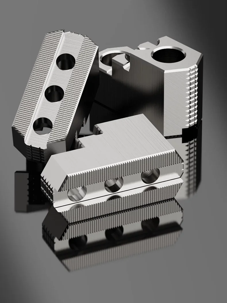 A set of three three-step hard jaws positioned in different orientations to show various details.