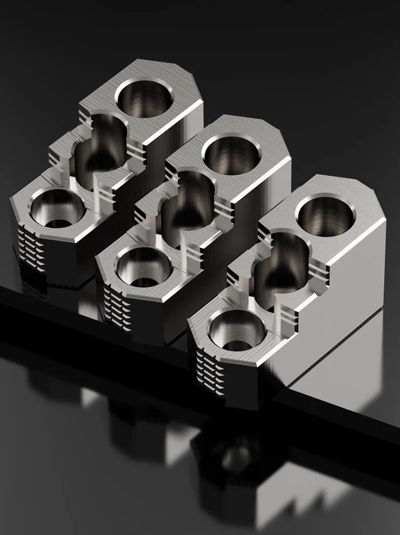 A set of three hardened steel, three-step jaws displayed side by side.